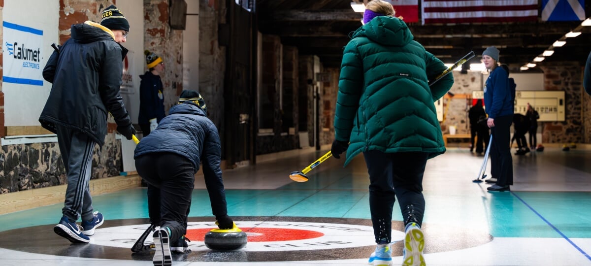 In 2025, its first full season as a registered student organization, Huskies Curl elevated both its membership numbers and performance in national competition. Students curling at the Calumet Drillhouse.