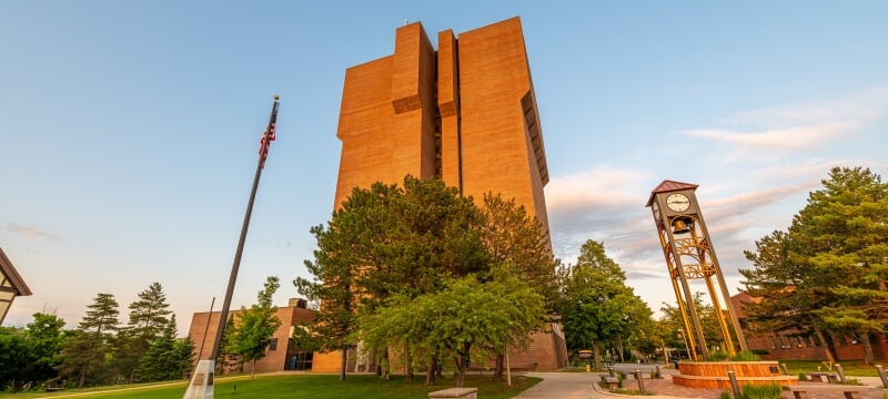 The R. L. Smith Building and clock tower lit by the setting sun.