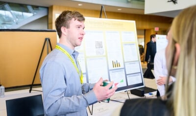 A Senior Design student presents his work to judges.