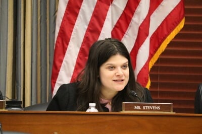 Representative Haley Stevens addressed the assembled experts from a lectern. 