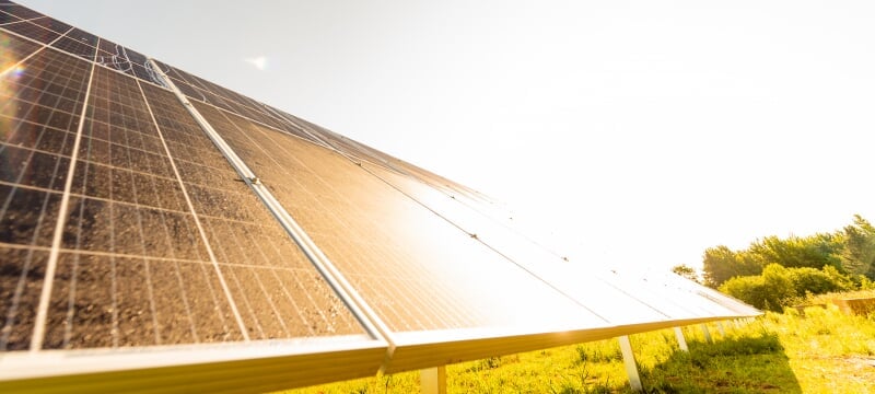 A large solar panel reflects the sun’s glare.