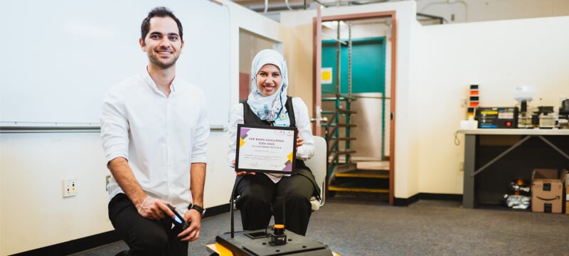 Amna Mazen and Kamyab Yazdipaz with the award and robot.