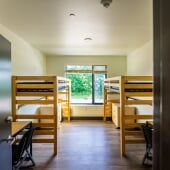 East Hall standard double suite at Michigan Tech with two lofted beds, desks, and a large window.