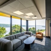 East Hall community lounge with modern seating and panoramic views of the water.