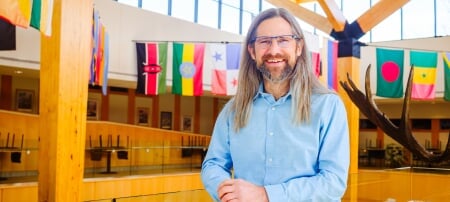 Michigan Tech researcher and renowned wildlife ecologist John Vucetich, shown here in the atrium of the College of Forest Resources and Environmental Science, has been honored with the Universityâ€™s 2025 Research Award.