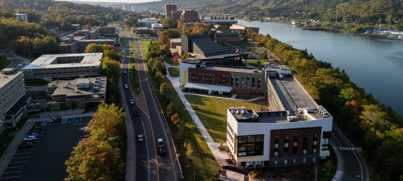Aerial view of Michigan Technological University’s East Hall with the Portage Canal and campus buildings stretching into the distance.