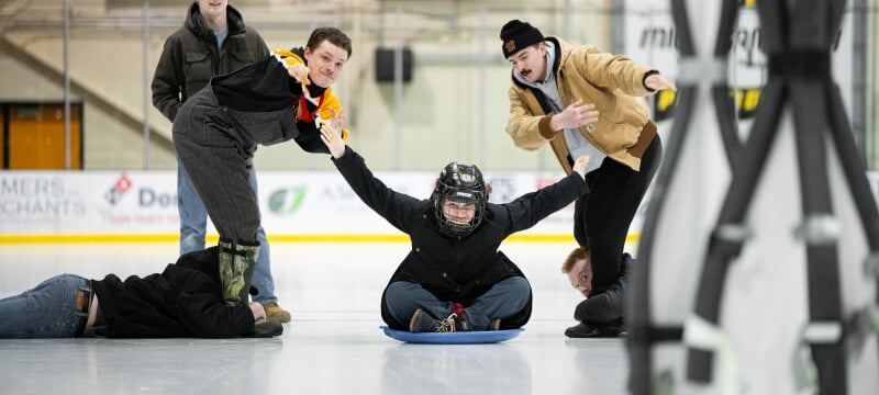 A team of four people participate in the human ice bowling event at the Student Ice Arena.