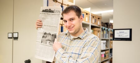 Husky Ethan Rice’s mom and dad were Blue Key National Honor Society members like him — and they got engaged at Winter Carnival Stage Revue. During a visit to the Michigan Tech Archives, Ethan holds a copy of the Michigan Tech Lode, pointing to the story about his parents which was featured in the Friday, Feb. 11, 2020 issue of the paper.