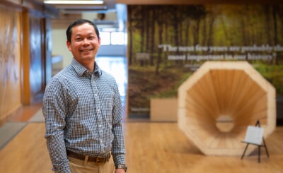 Xinfeng Xie standing in a hallway in the Noblet Forestry Building.