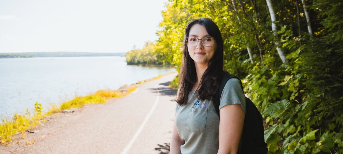 Two years ago, the field of acoustics was brand new to Jennifer Celeste. Now, the Michigan Tech junior and Barry Goldwater Scholarship recipient is ready to take the field by storm. Jennifer Celeste stands with a backpack over her shoulder on a paved waterfront trail.
