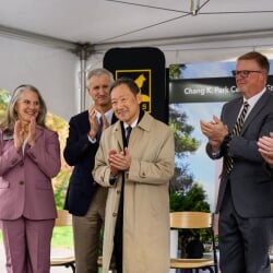 Laura Bulleit, President Koubek, Jon Jipping, and Greg Markanen standing around Chang K. Park, all clapping.