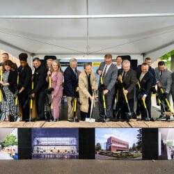 Board members, President's Council, Greg Markanen, and Chang K. Park shoveling the cermonial dirt on stage.