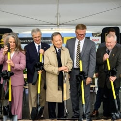 Several people holding shovels after the ceremonial groundbreaking.