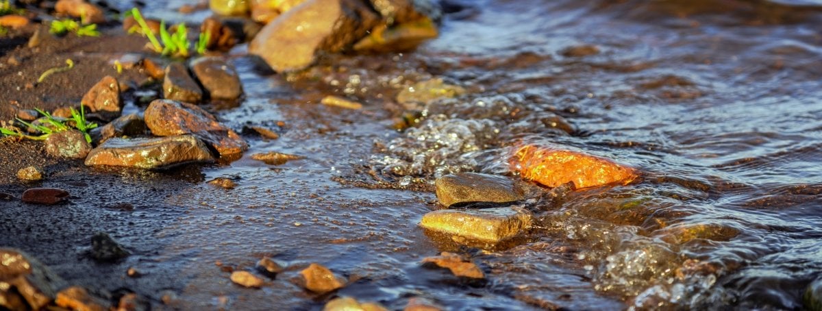 A wave lapping along some rocks.