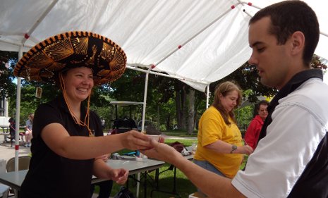 Kristin Beck, Sponsored Programs, gives Matt McCormick, Career Center/Alumni Relations, a taste of Relampago Blanco.