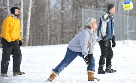 Victoria Demers returns the ball in the snow volleyball special event with Mu Beta Psi teammates.