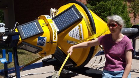 Sarah Green, chair of chemistry and a researcher on the Great Lakes Observing System project, takes a look at the custom-made coastal monitoring buoy delivered to Michigan Tech.