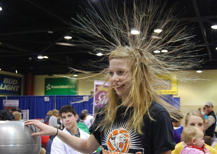 Touching a Van de Graaff generator makes your hair stand on end.