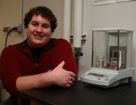 Patrick Bowen tracks the weight gain of a brick sample, part of his research to refine a new technique for dating old ceramics.