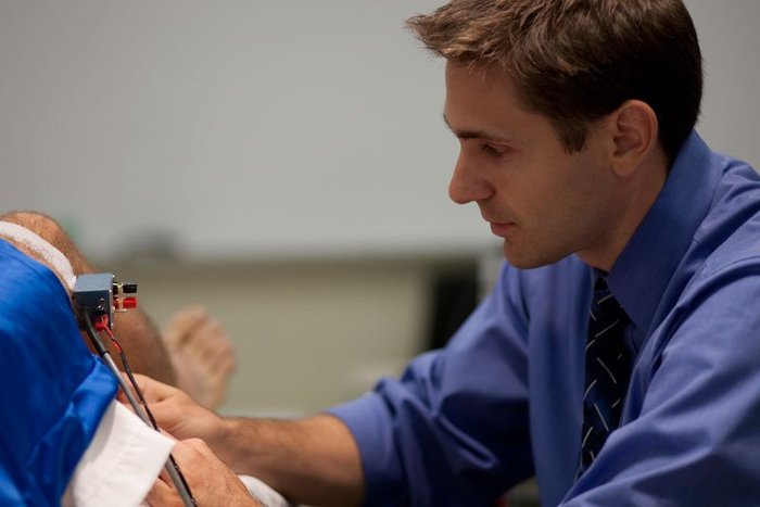 Jason Carter attaches sensors in his lab.