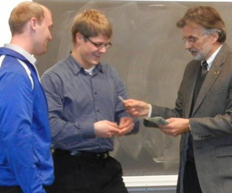 First-place winners Travis Beaulieu and Joel Florek receive $1,000 from Dean Darrell Radson.