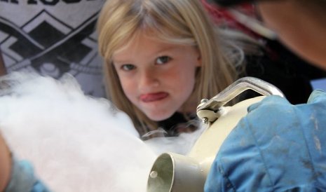 A little girl can't wait to taste liquid nitrogen ice cream. 