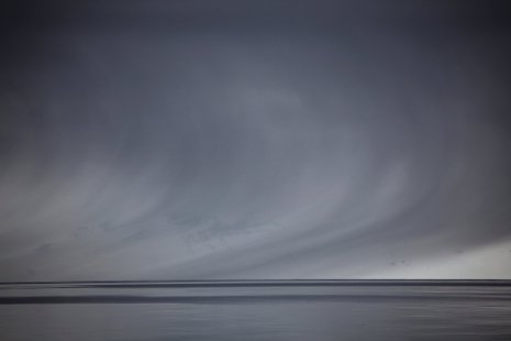 Scientists have long puzzled over the seemingly ceaseless drizzle of snow drifting down from arctic clouds, like these in the ocean off Norway's north coast. A team led by Michigan Tech's Raymond Shaw may have an answer. Thinkstock photo