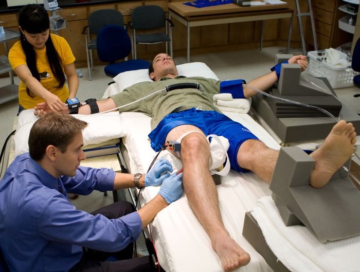 Jason Carter and Huan Yang set up a subject in their lab for stress testing.