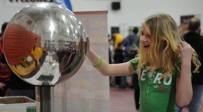 Touching a Van de Graaff generator makes your hair stand on end - literally.