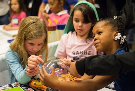 Students experiment with a plasma ball at a Mind Trekkers science and engineering festival.