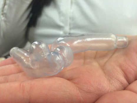 Kathleen Ikeda holds a 3-D printed plastic model of an artery in her hand. 