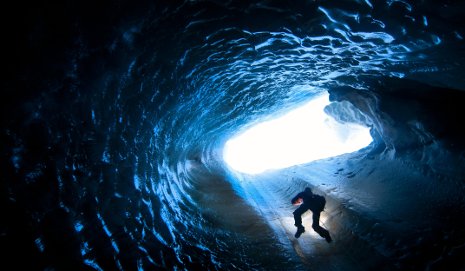 A researcher rappels into an ice cave in Svalbard, an archipelago in the Arctic Ocean off the northernmost tip of Europe.  Photo by Jason Gulley