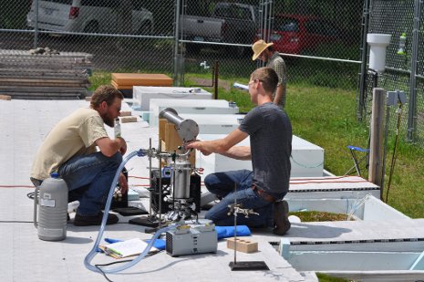 Evan Kane and his research collaborators study peat bog mesocosms.