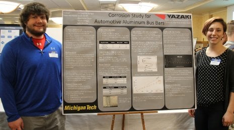 Senior Design Team members Kyle Myszka and Annie LeSage present their team's winning poster at the 2015 Design Expo.