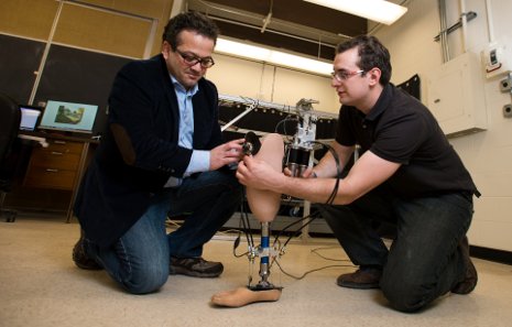 Mo Rastgaar (left) and PhD candidate Evandro Ficanha test the new robotic ankle that can "see" where it's going.