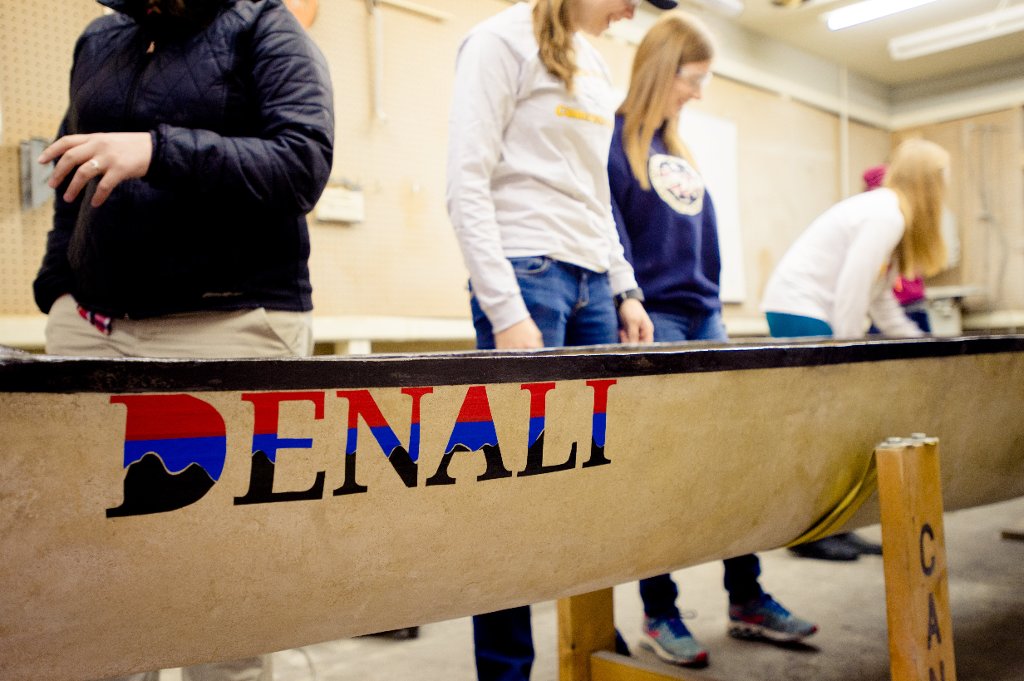Team members put the finishing touches on their concrete canoe, named Denali for  the National Parks theme. 