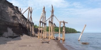 The historic wooden sluiceway stands on the shoreline where the sands that covered it have eroded away