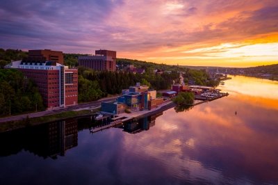 The buildings of Michigan Tech along the Keweenaw Waterway at sunset.