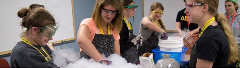 Summer Youth Programs students working on an experiment involving dry ice.