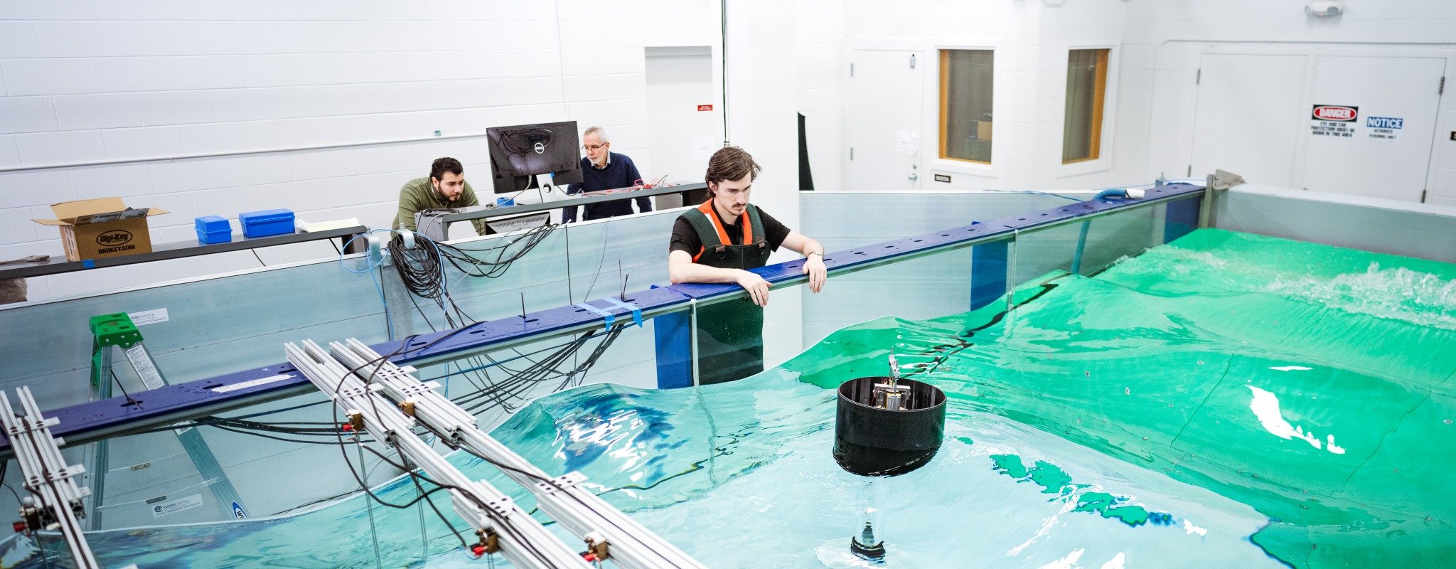 Professor Gordon Parker leads students in a demonstration of a Wave Energy Converter in the Wave Pool located inside the ME-EM Building.