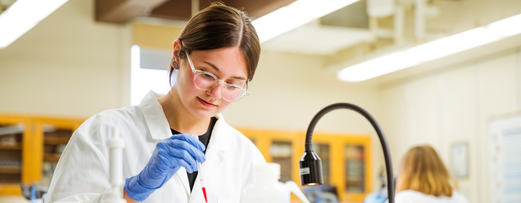 A Michigan Tech student tests samples in a lab in one of the university's many health sciences programs.