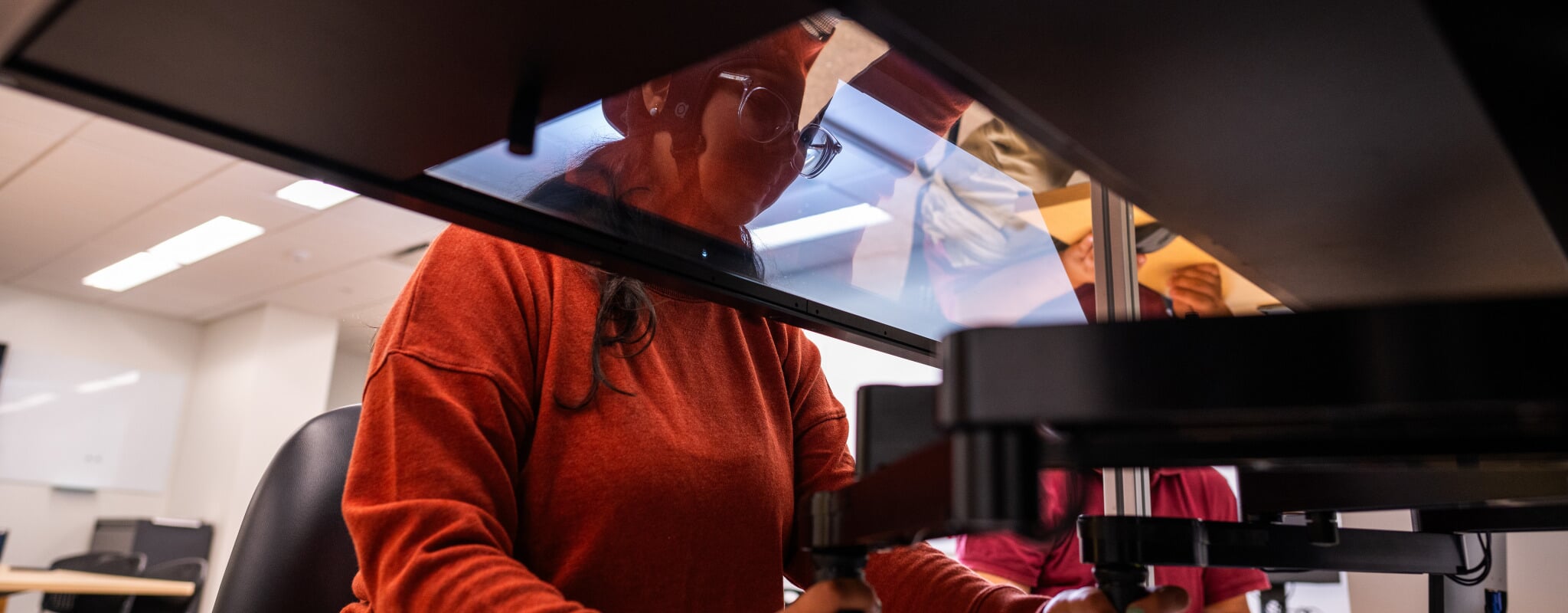 Researchers track input in the Michigan Tech lab where Space Trash is being developed as Melanie Frias Veras plays the game