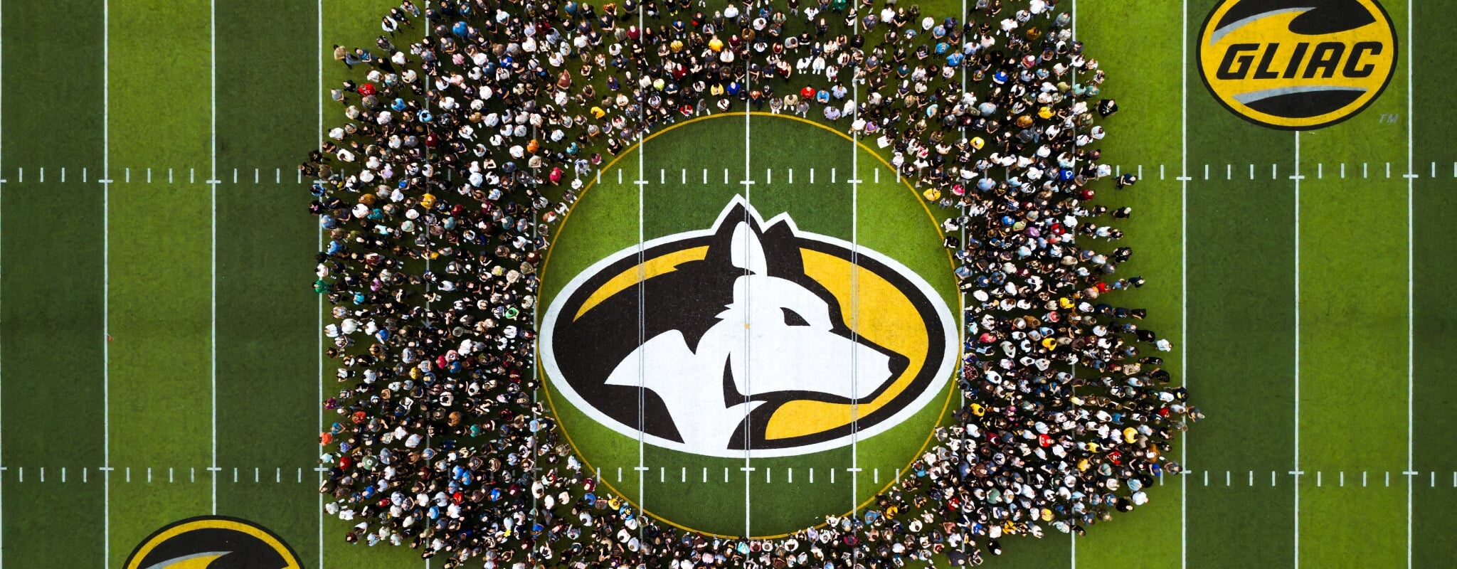 Michigan Tech's class of 2030 gathers on the football field for their class photo