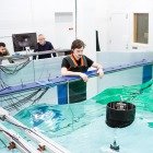 Huskies Make Waves - With digitally controlled paddles, an array of gauges, and an optical tracking system, Michigan Tech’s wave tank creates reproducible wave fields that aid understanding of motion in submerged and partially submerged materials, like underwater vehicles, ships, and devices with moving elements that act as wave energy converters (WEC).