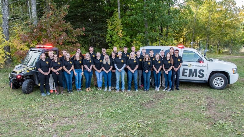 EMS Crew standiing in front of ems vehicle and atv