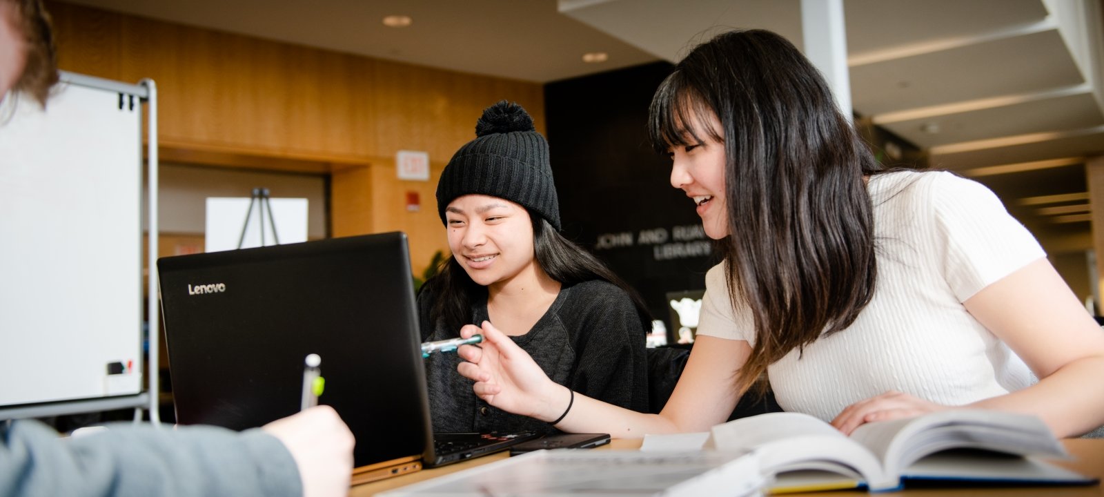 Two students looking at a laptop