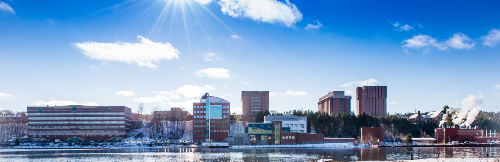 Michigan Tech campus from across the Portage waterway on a clear, sunny, winter day.