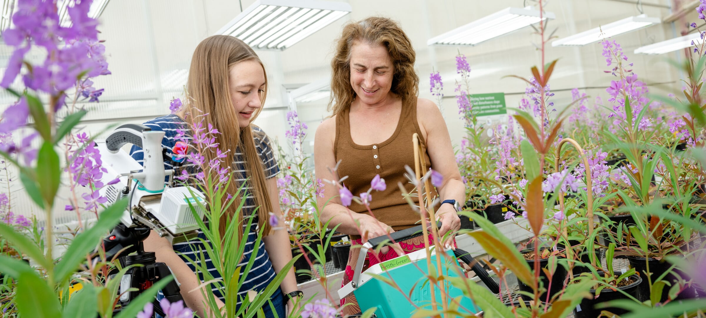Two women working the Dow Greenhouse