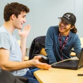 Two students talking and laughing