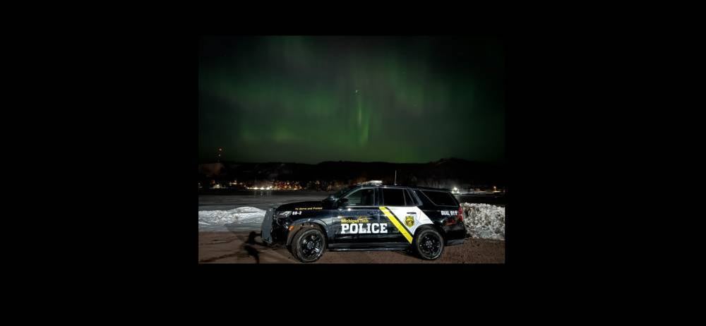 Public Safety Patrol Car under the Northern Lights on Campus